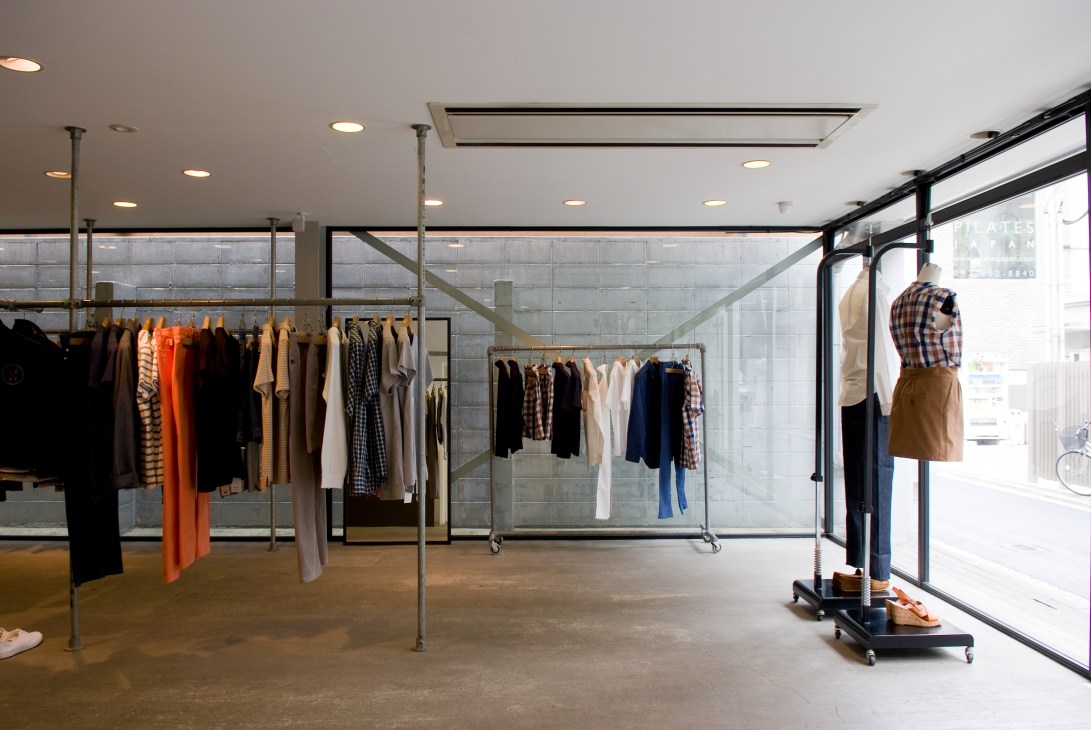 A.P.C. fashion store interior with clothing racks and minimalist design