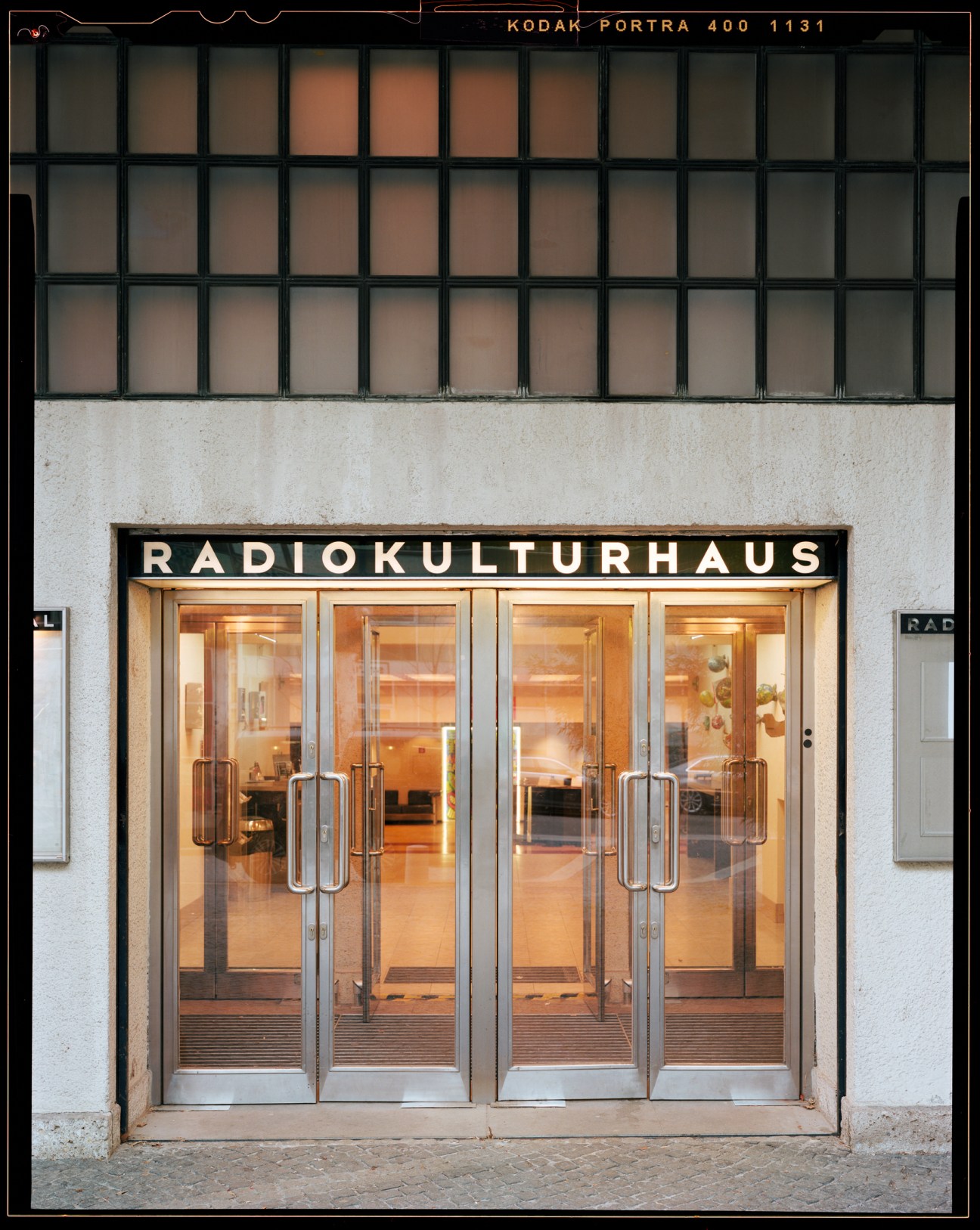 Glass entrance doors to RadioKulturhaus with illuminated signage above