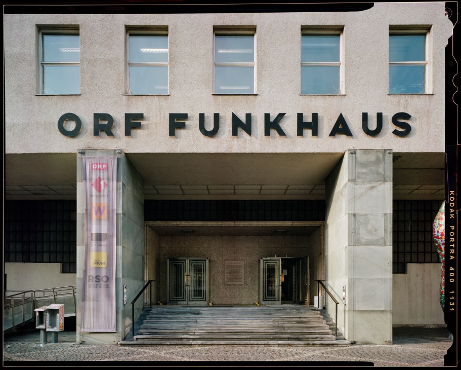 Modern concrete building entrance with ORF FUNKHAUS lettering above covered entryway and windows