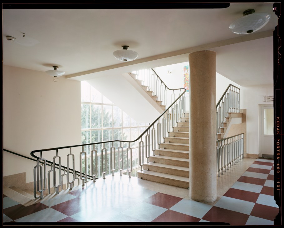 Elegant staircase with metal railings and checkered marble floor in Vienna's Funkhaus broadcasting building