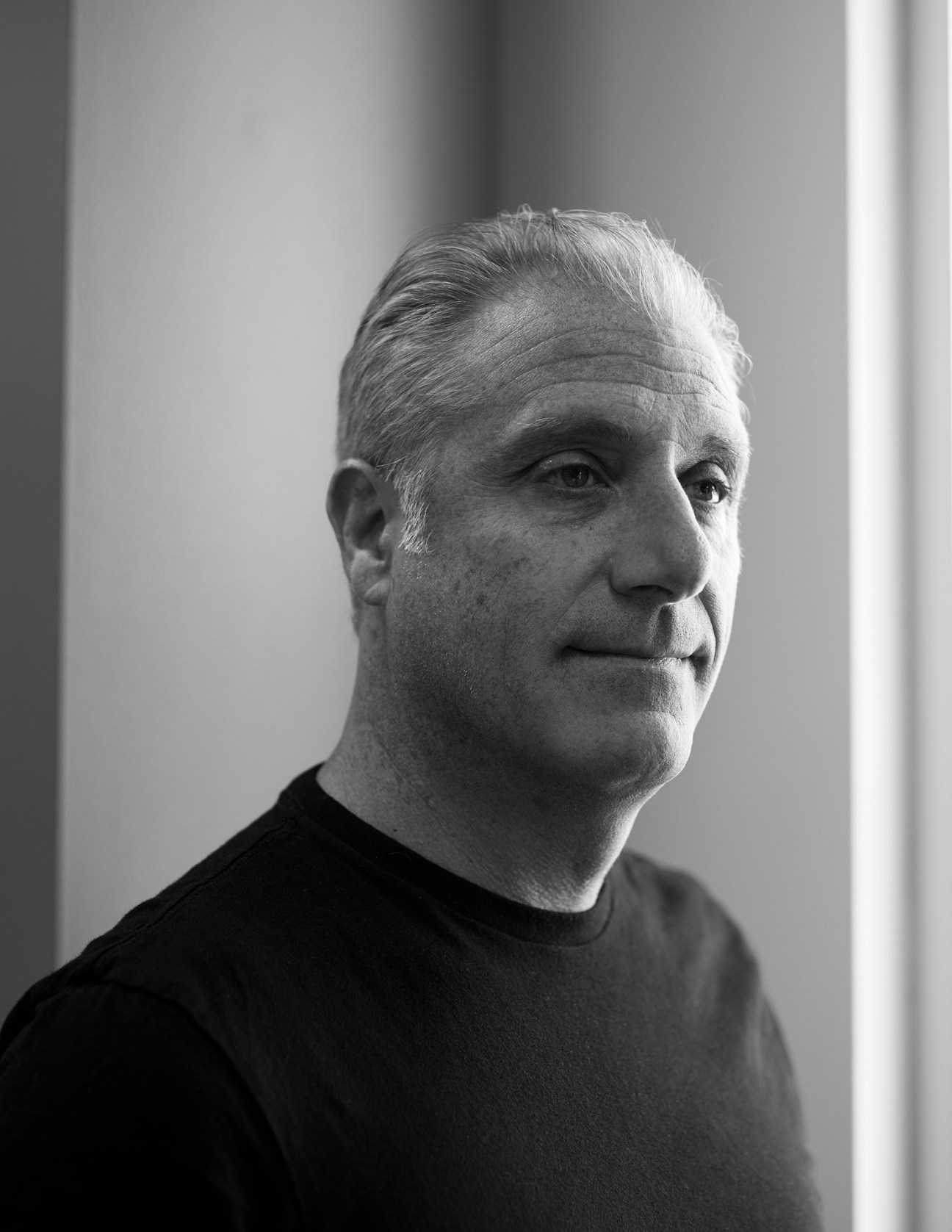 Black and white portrait of Paul Gaudio, Adidas global creative director, against a plain background.