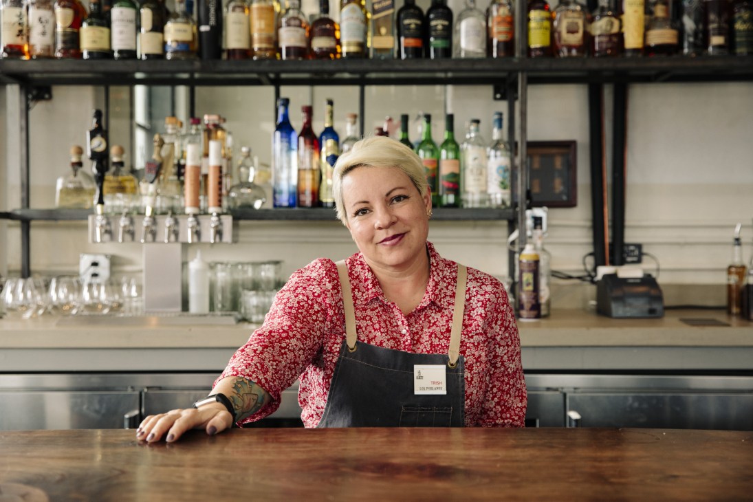 Bartender Trish standing behind the bar at Campo restaurant in Albuquerque