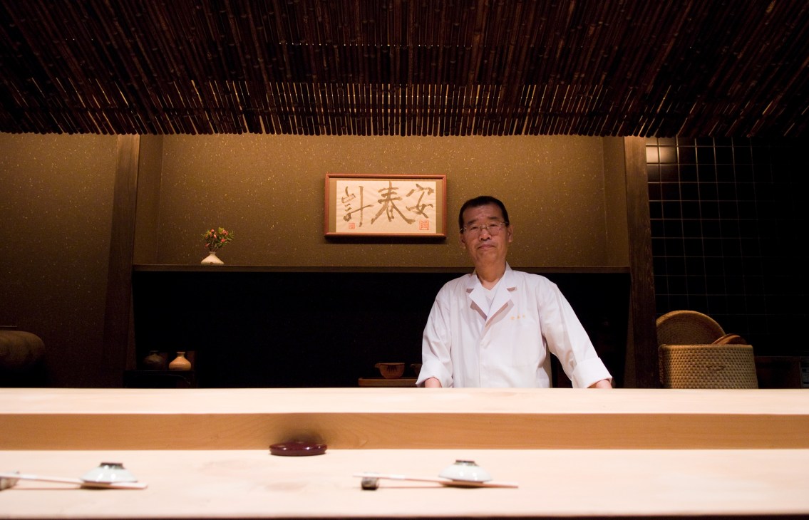 Sushi chef Masahiko Takasaki stands behind the counter at his eight-seat sushi restaurant Asuke.