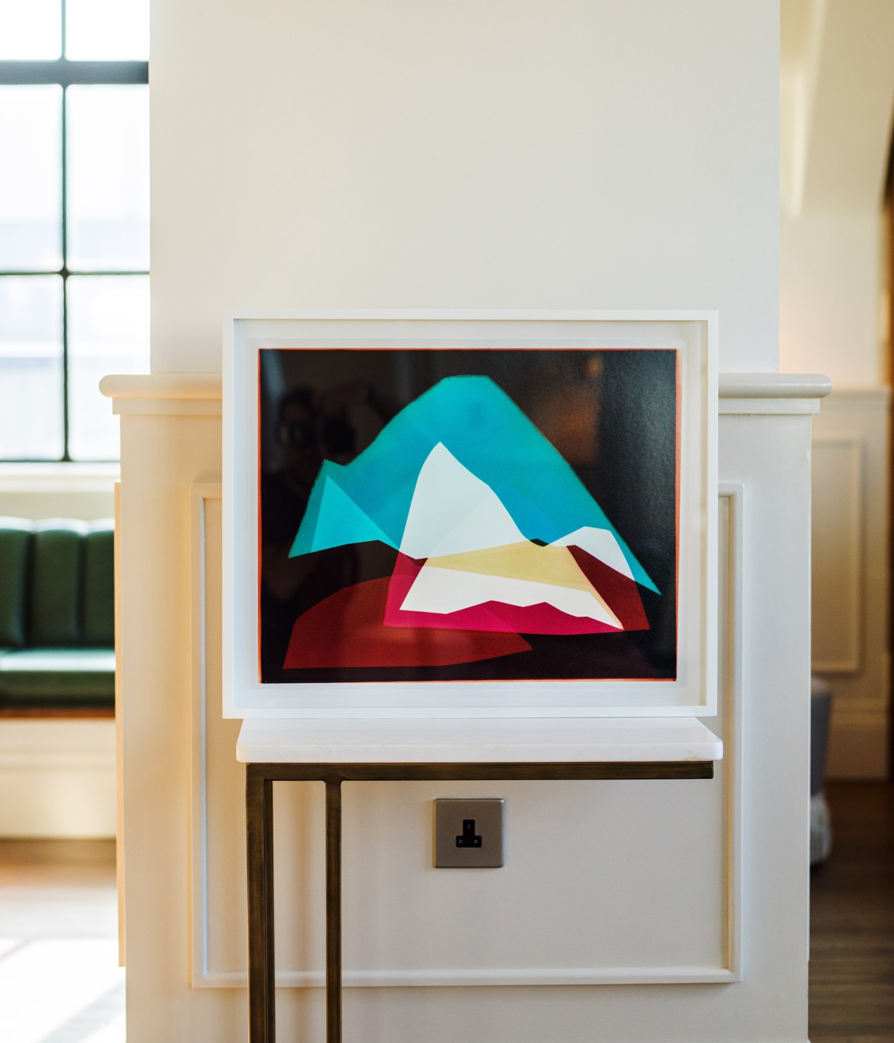 Framed abstract artwork by Liz Nielsen featuring layered geometric shapes in turquoise, white, red and yellow on black background.