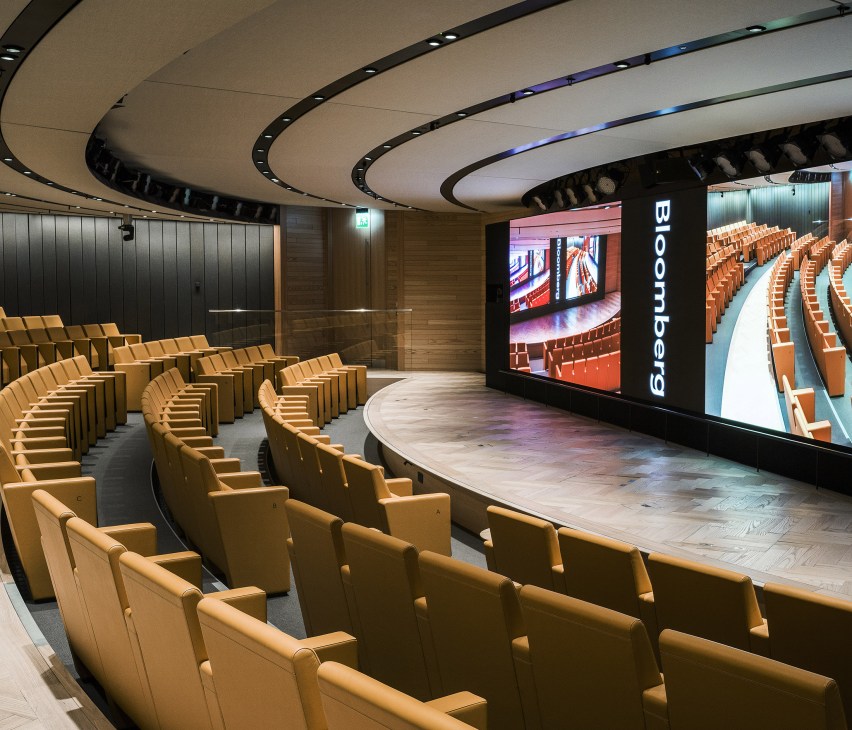 Interior of Bloomberg auditorium with tiered seating and modern presentation setup
