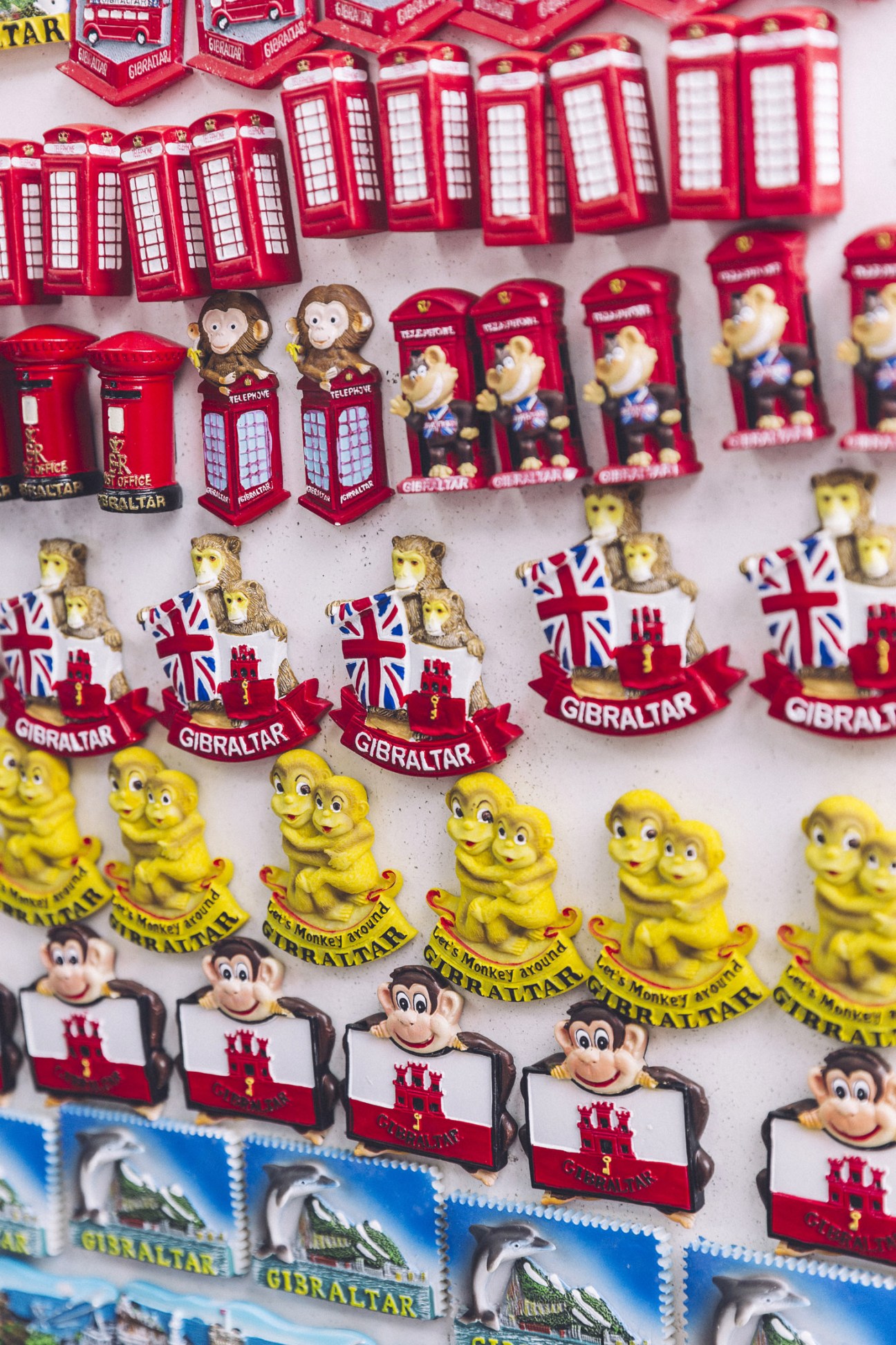 Display of Gibraltar souvenirs including red telephone boxes, monkeys, British flags and Queen figurines