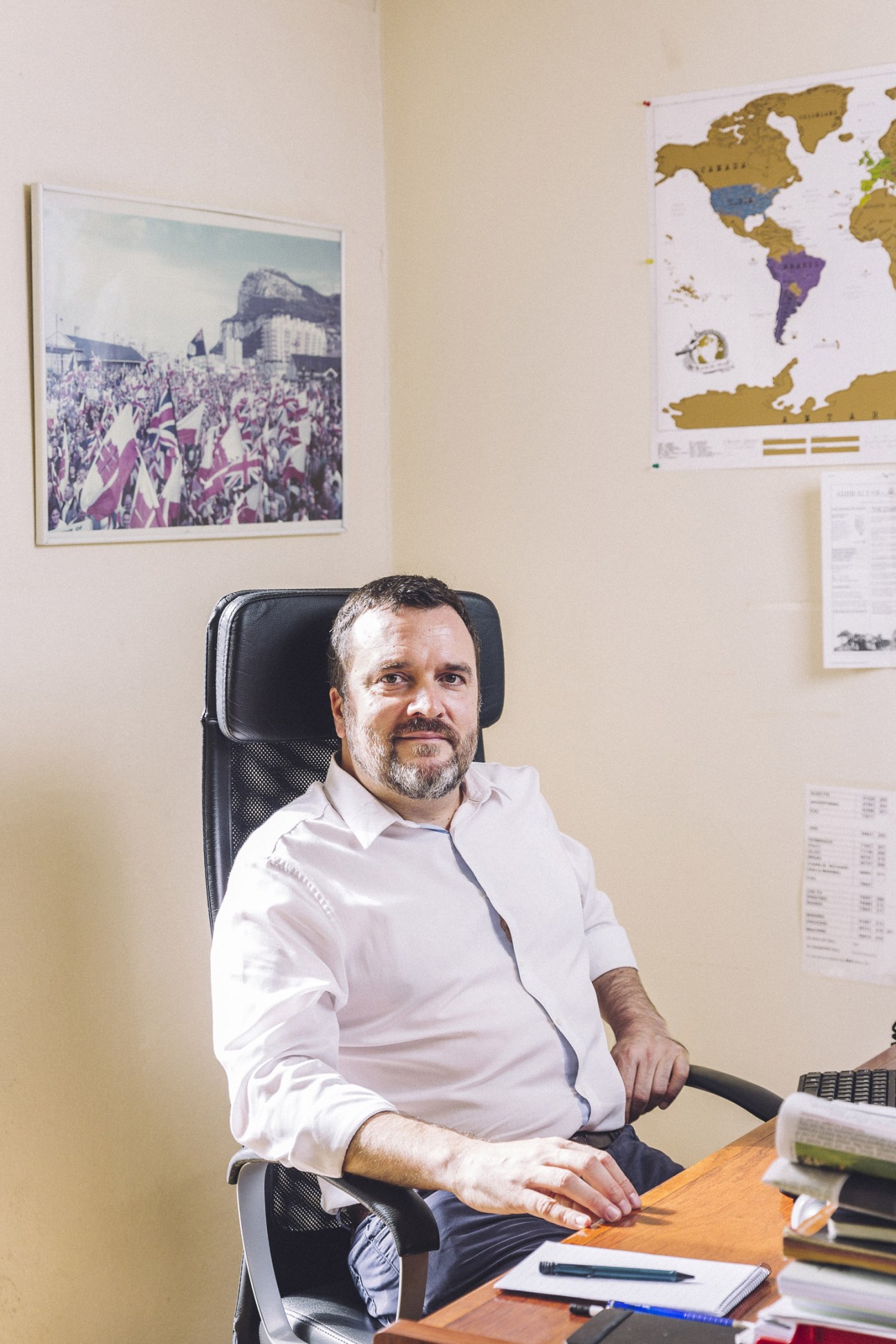 Brian Reyes, editor of the Gibraltar Chronicle, seated at his desk in his office.