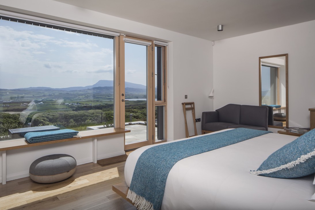 Breac House guest room with floor-to-ceiling windows overlooking mountains and Sheephaven Bay