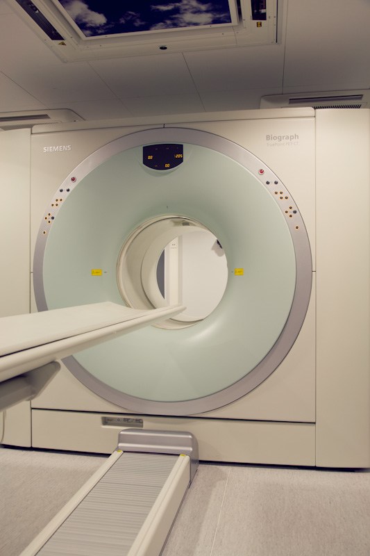 Siemens Biograph MRI scanner with white circular gantry and control panel