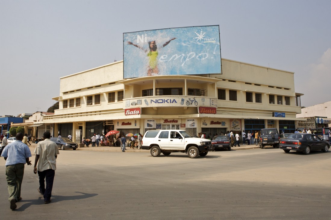 Art-deco building in Bujumbura city centre with commercial signage and billboard advertising.