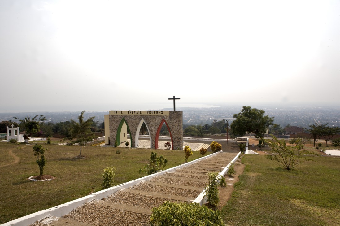 Independence monument with cross on hilltop overlooking Bujumbura landscape