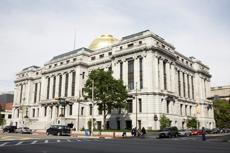 Newark's City Hall, a grand neoclassical building with white stone facade, columns, and gold dome.