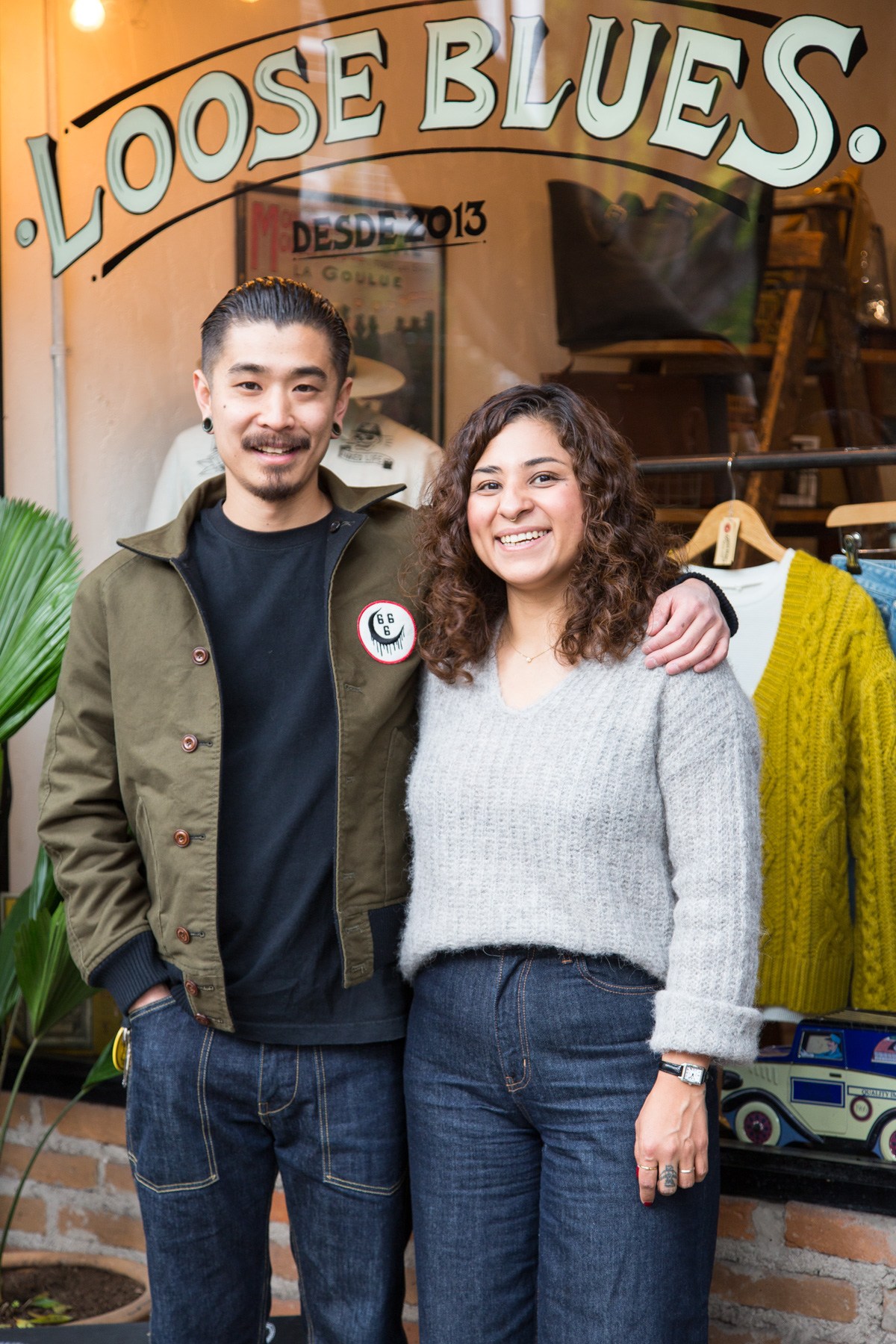 Two people smiling outside Loose Blues shop in Mexico City