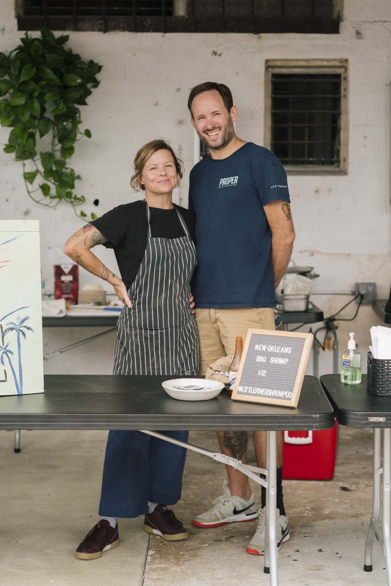 Freddy Kaufmann and his wife standing behind a counter at their food business in Little River, Miami.