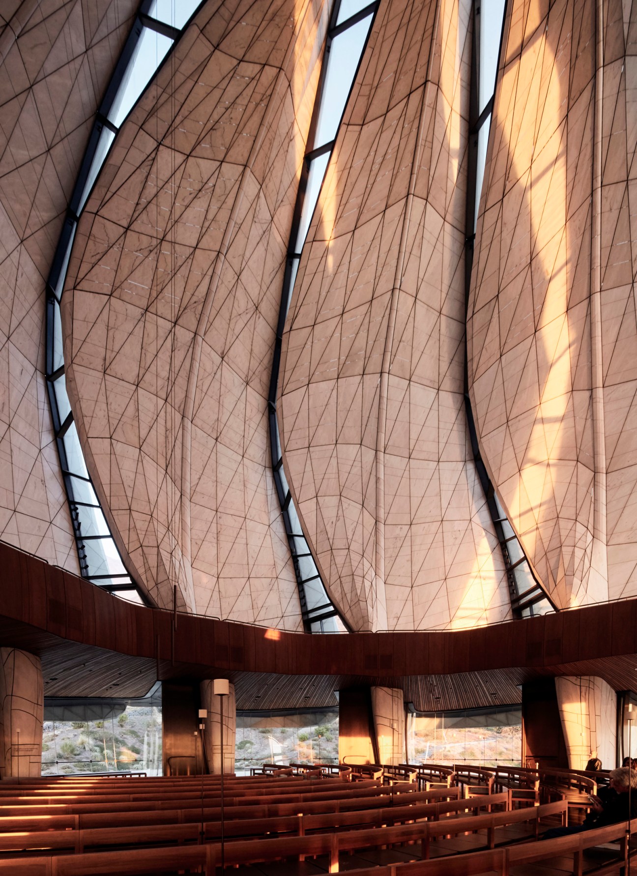 Interior of the Baha'i House of Worship showing frosted glass veils with dramatic natural light streaming through.
