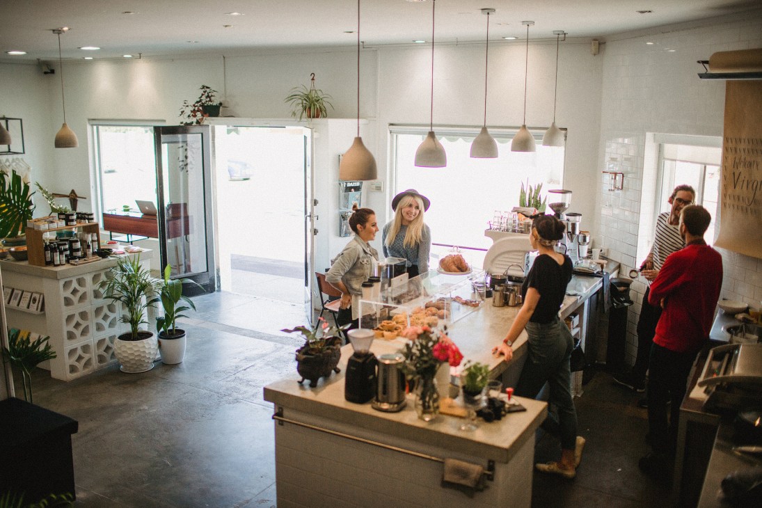 Virgil Coffee café interior with customers and staff at counter, featuring pendant lights and potted plants at 324 Oxford in Perth.