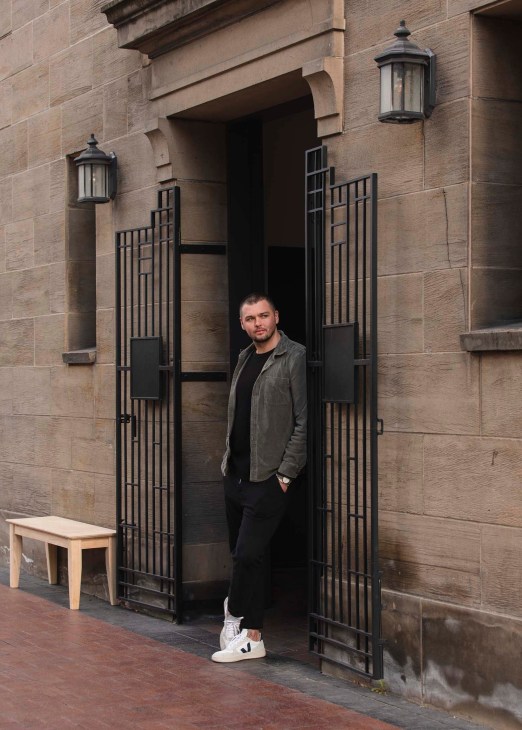 Lucas Marshall stands in the doorway of his menswear shop Marshall Goods in Boise, Idaho.