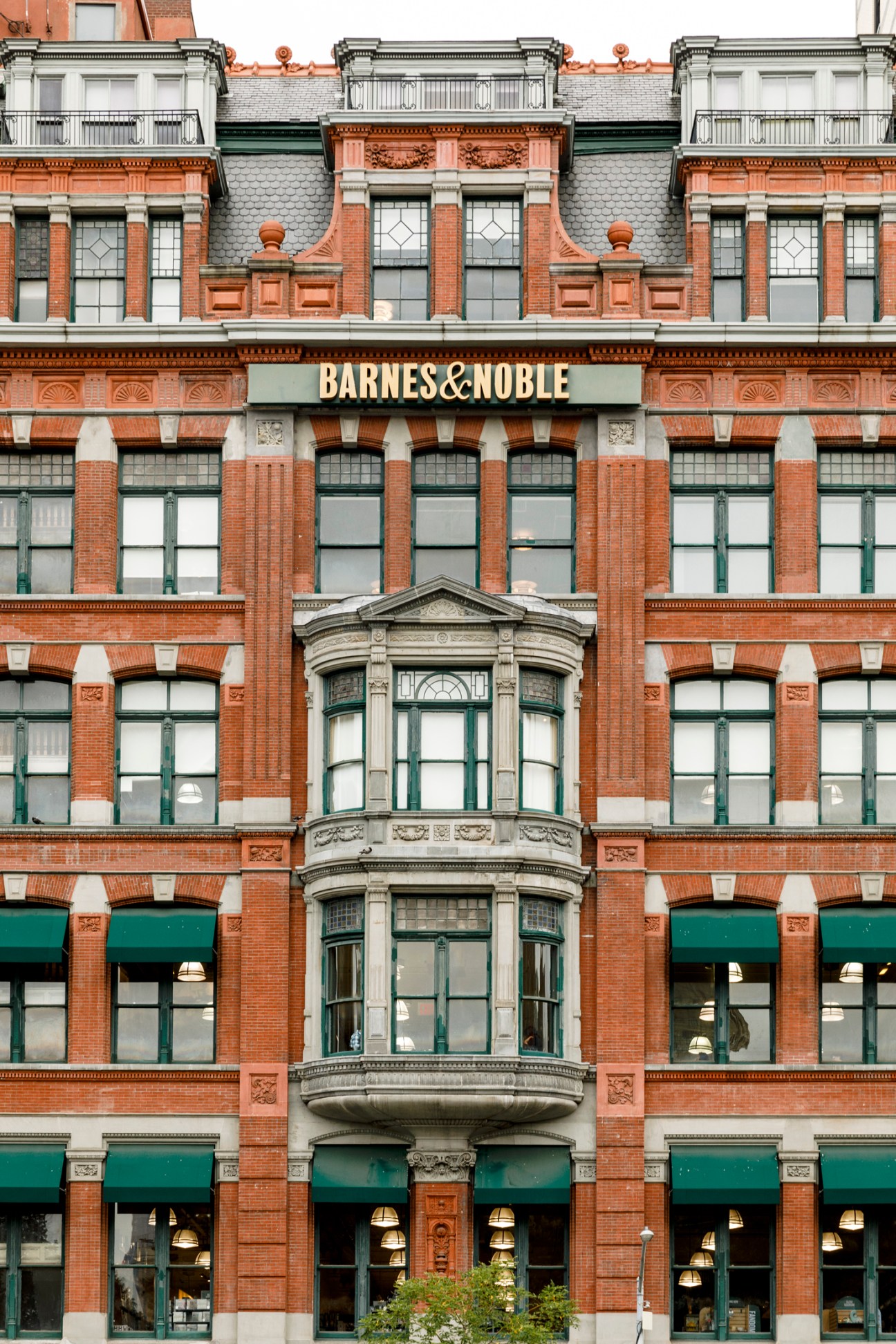 Historic brick Barnes & Noble bookstore building with ornate architecture and green awnings
