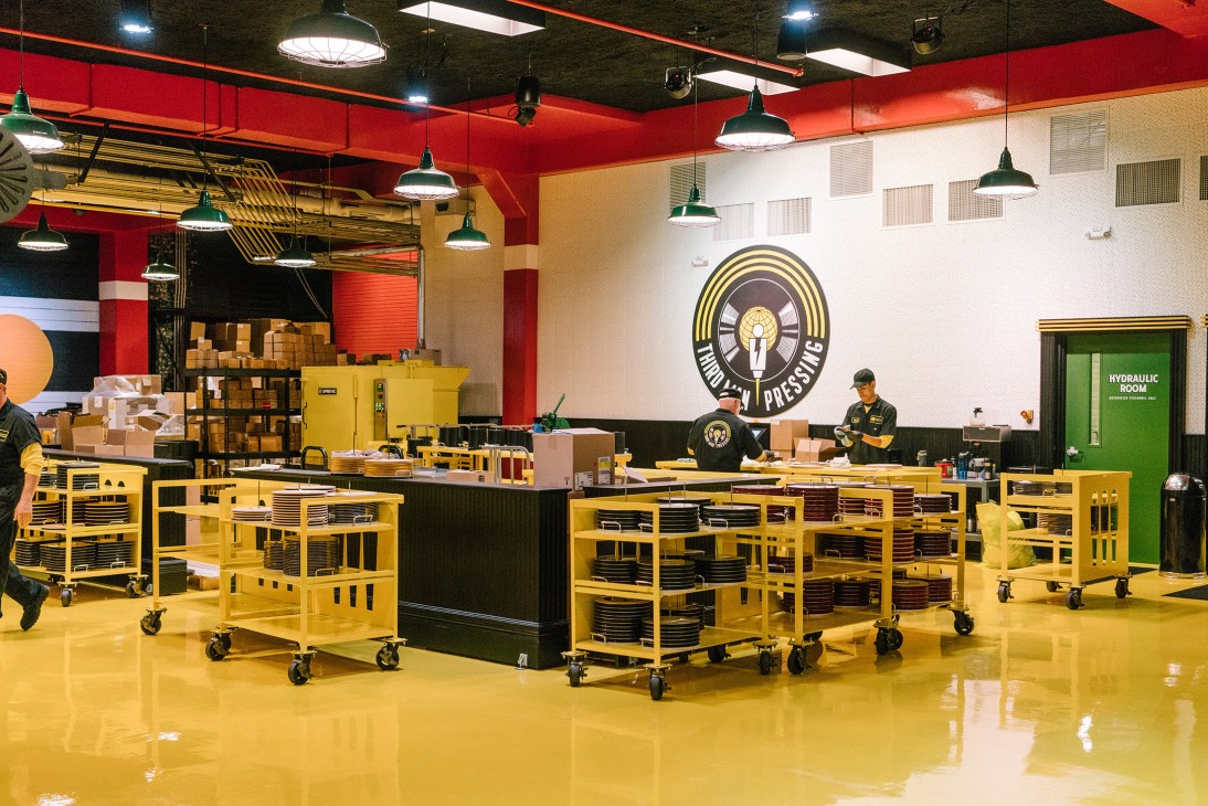 Interior of Third Man Pressing vinyl facility with yellow storage carts and red ceiling in Detroit's Cass Corridor.