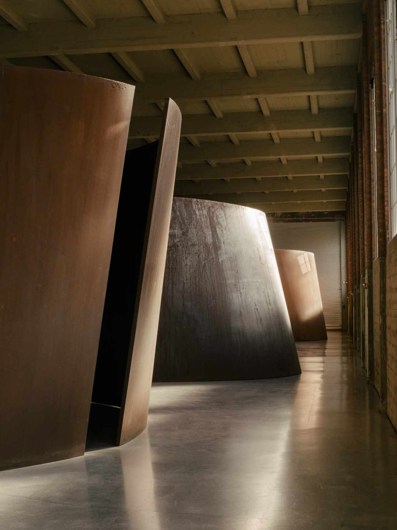 Interior view of Dia Beacon art museum with large abstract sculptural installations and natural light