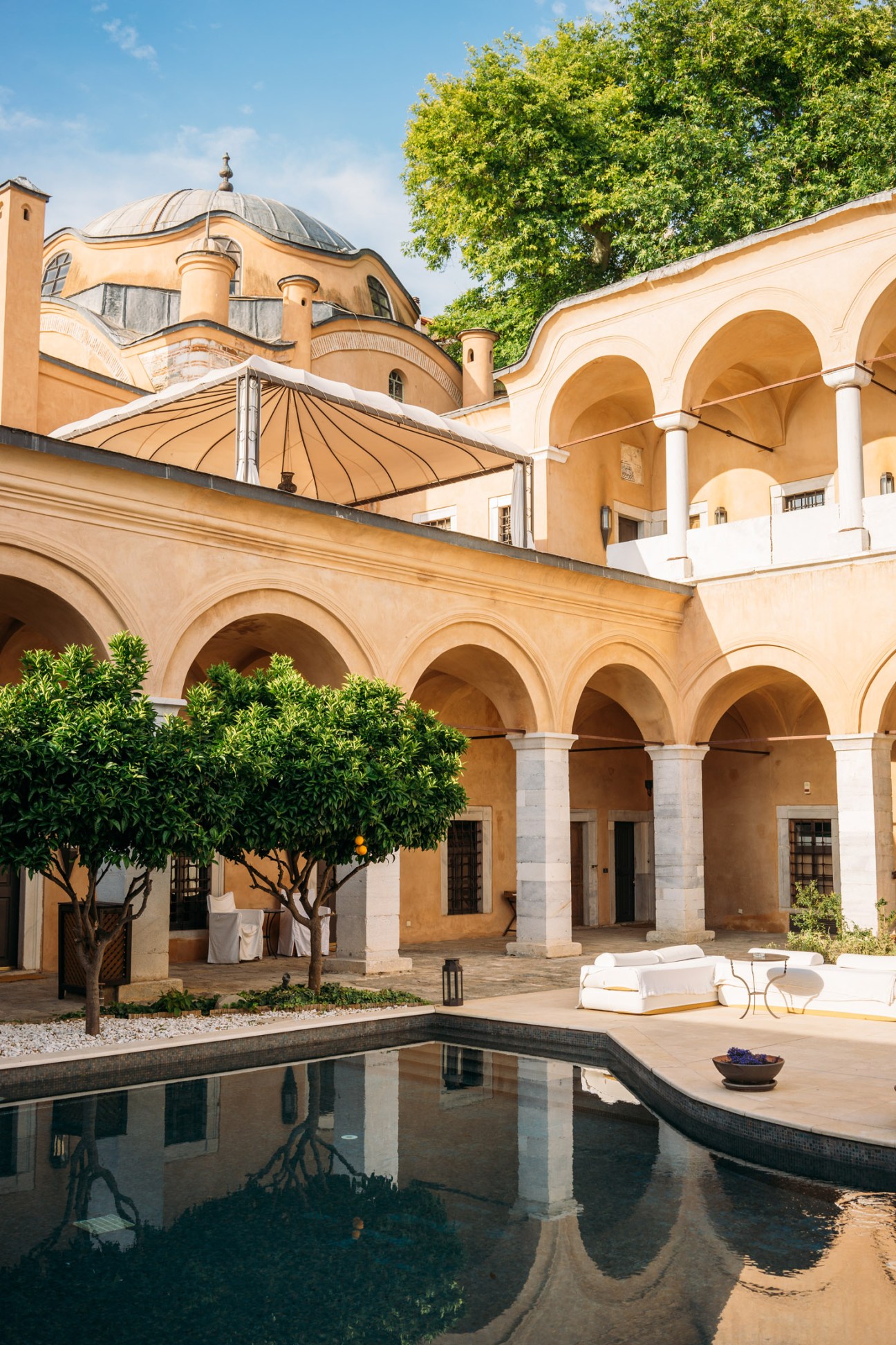 The Imaret hotel's courtyard with Ottoman arches, dome and reflecting pool in Kavala, Greece.