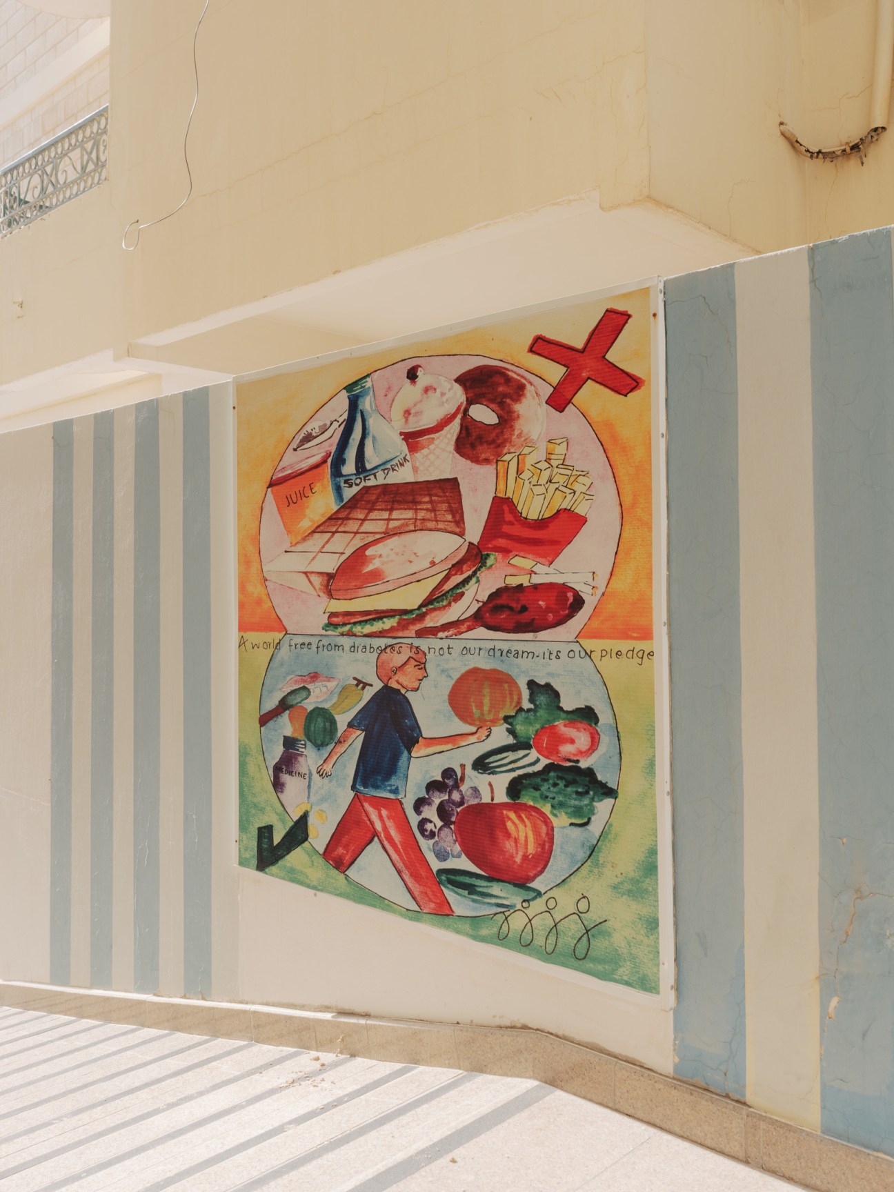 Health awareness mural showing contrasting fast food versus healthy food and exercise choices