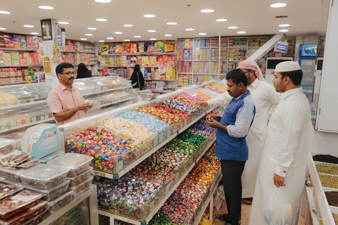 Colorful traditional sweets and confections displayed in Doha market stall