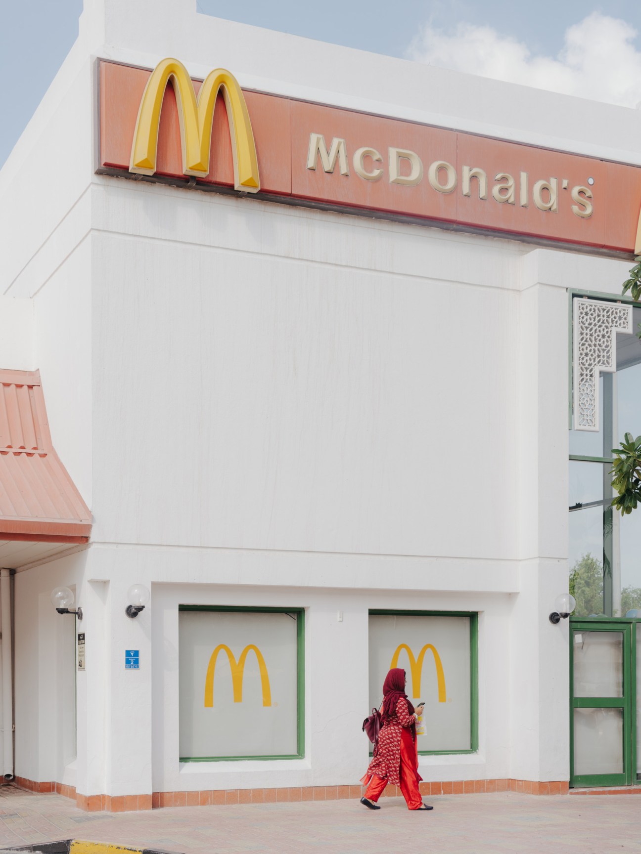 McDonald's restaurant exterior with golden arches sign and white facade in Doha