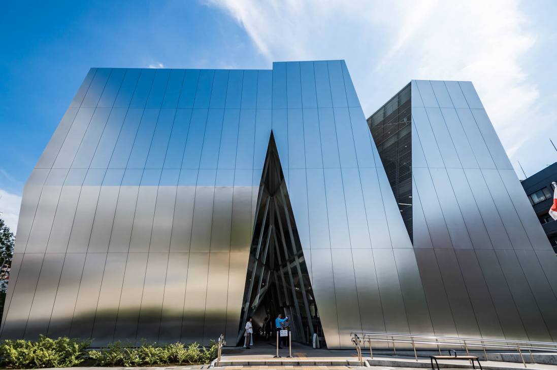 Sumida Hokusai Museum's distinctive angular architecture with white metal panels against a blue sky.