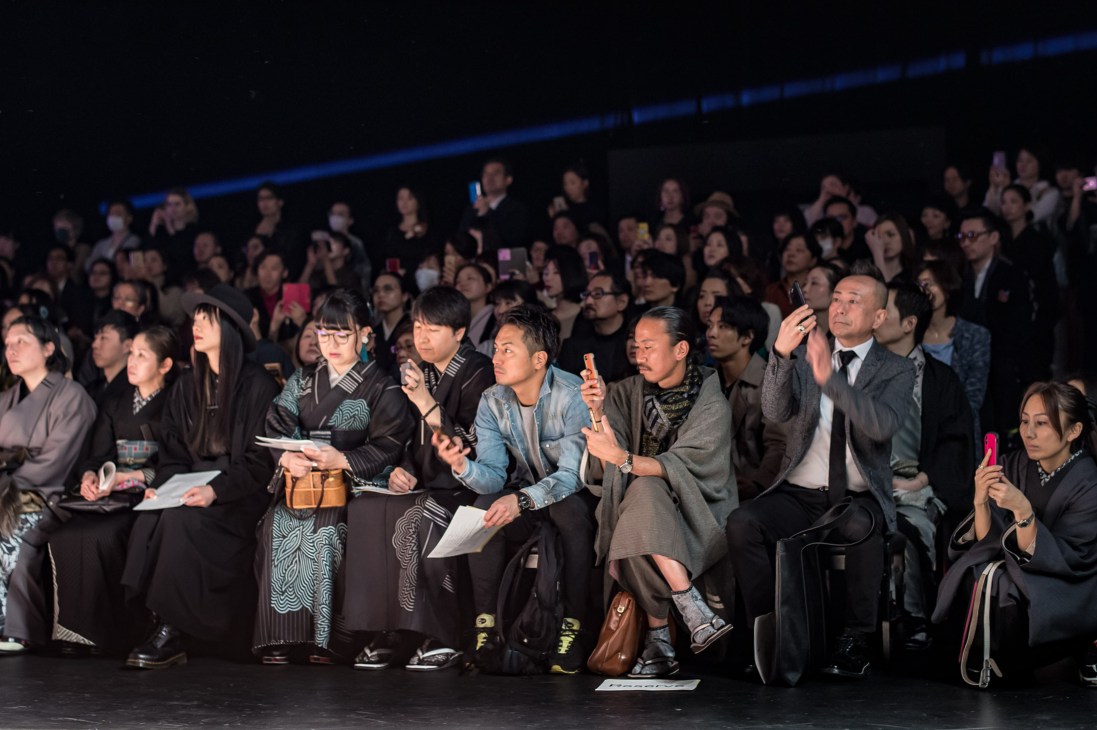 Seated audience watches a fashion show at Jotaro Saito during Tokyo Fashion Week.