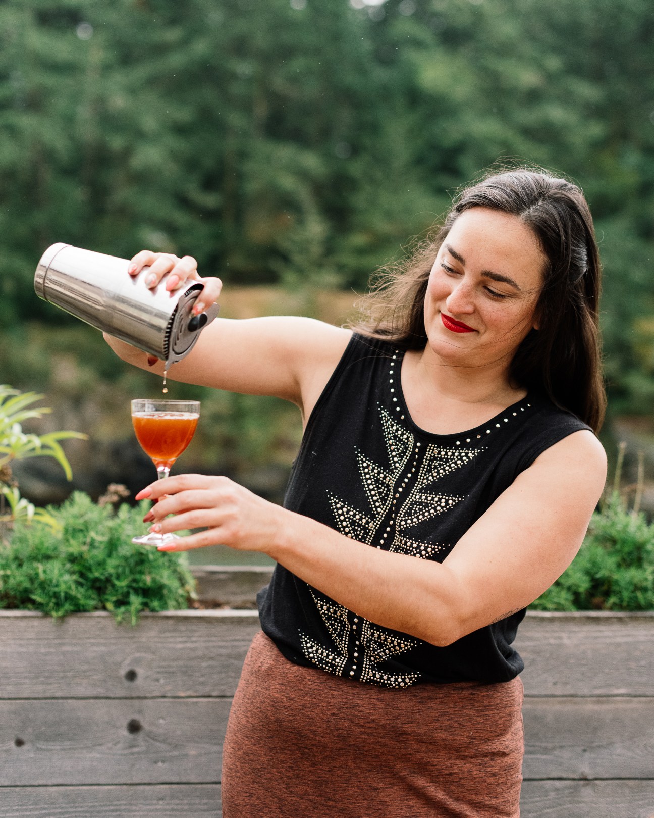 Jessie Poole, Doe Bay's front-of-house manager, pouring a negroni from a cocktail shaker