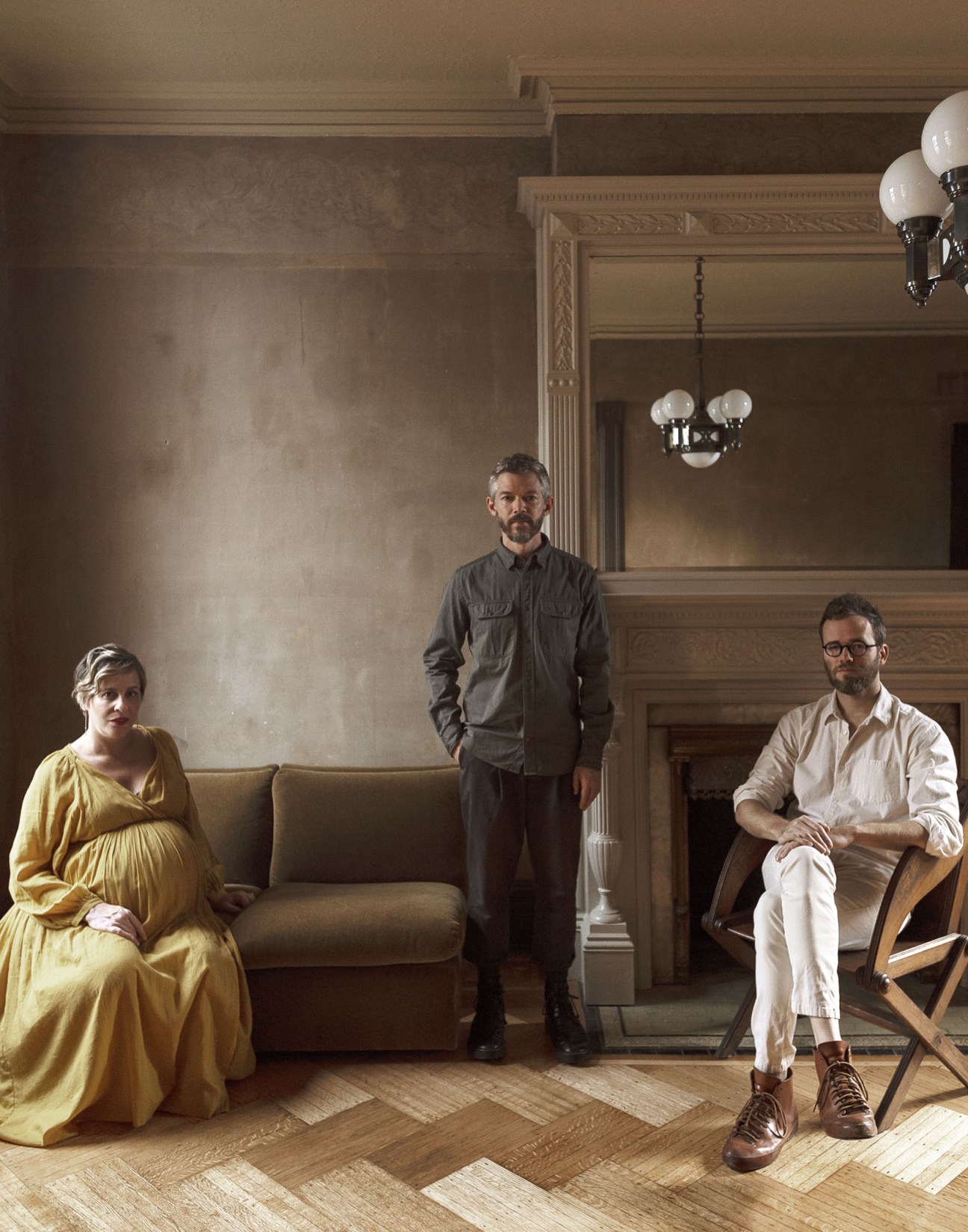 Three interior designers pose in a classical cream-coloured room: Stefanie Brechbuehler, Ryan Mahoney, and Robert Highsmith from Workstead.