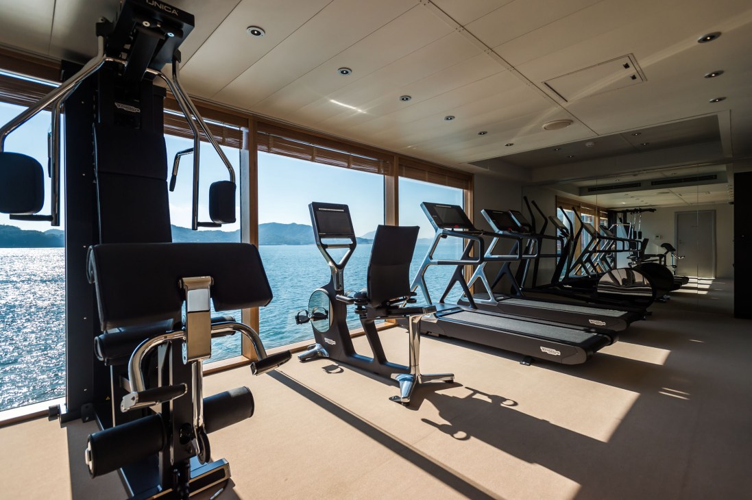 Fitness equipment including treadmills and exercise bikes line the windows of Guntu's gym overlooking the sea.