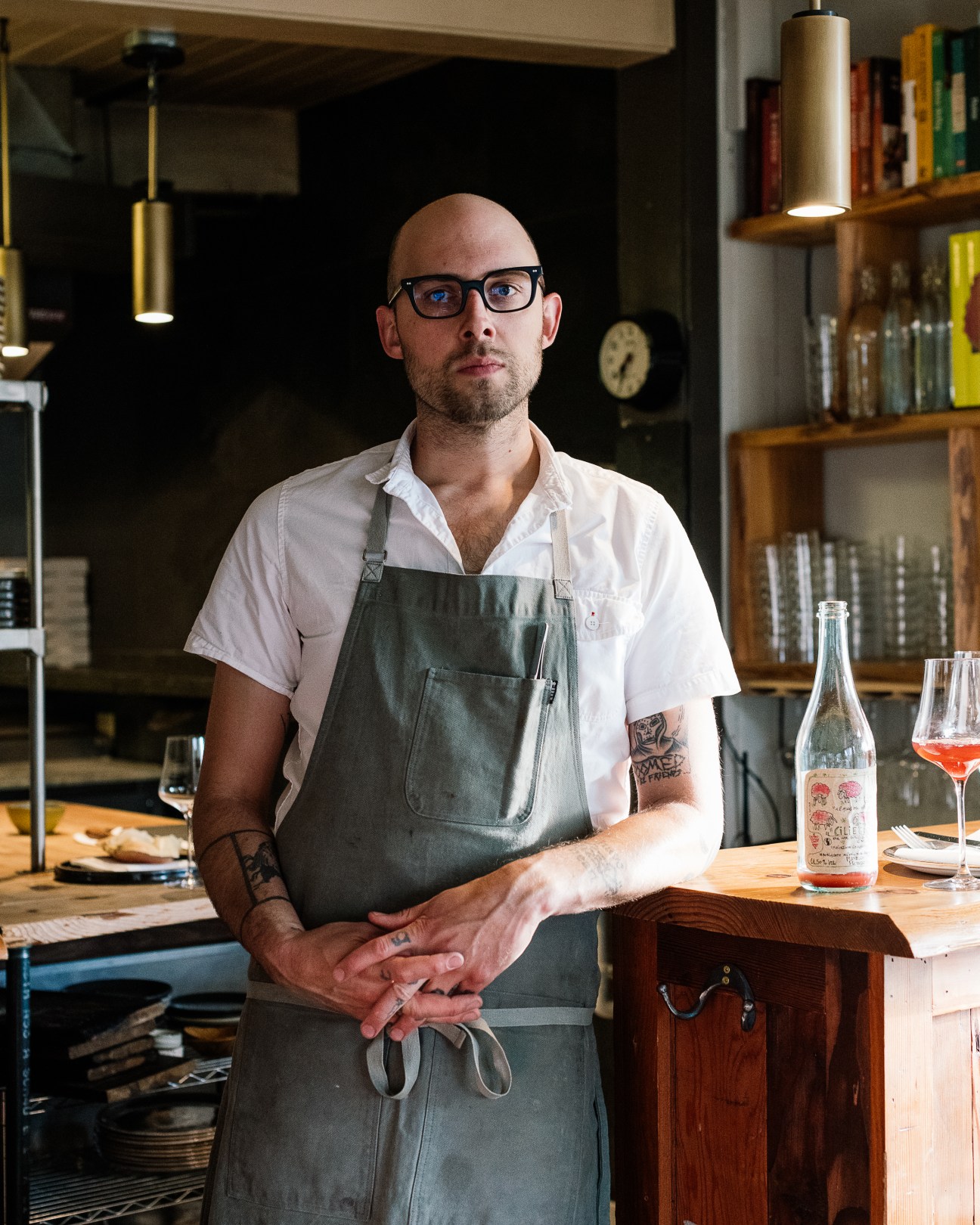 Jay Blackinton, co-owner-chef at Hogstone's, stands in his restaurant kitchen wearing glasses and an apron