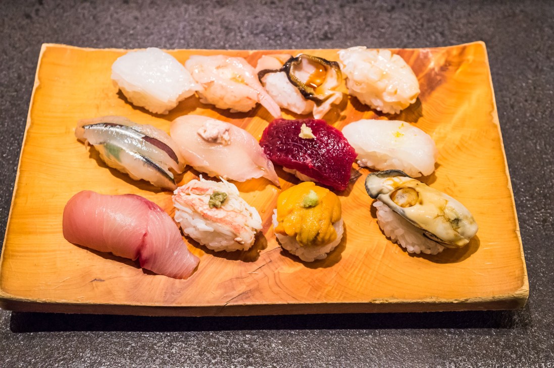 Assorted sushi pieces on a wooden plate at Ko Zushi restaurant