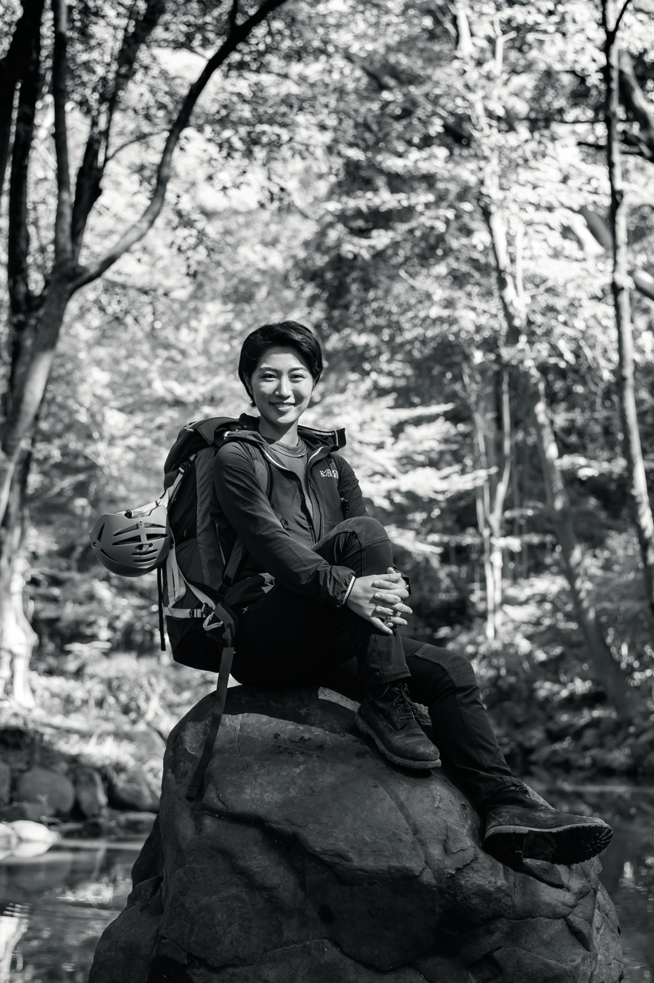 Portrait of Marin Minamiya, the youngest person to complete the Explorer's Grand Slam, sitting on rocks outdoors