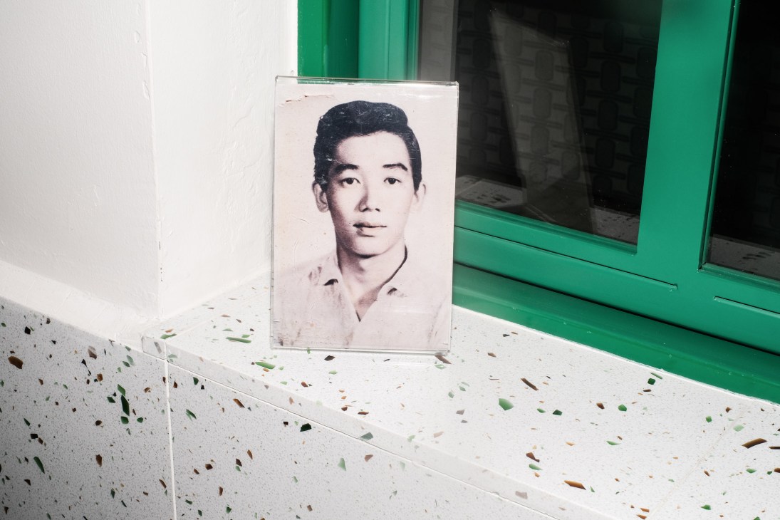 Vintage portrait photograph of Cynthia Chua's father displayed in a clear acrylic frame