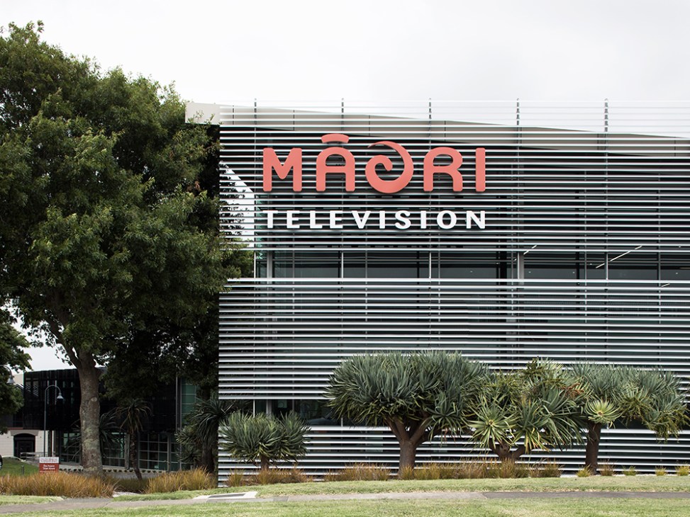 Maori Television's modern headquarters building with red and white signage in suburban Auckland.