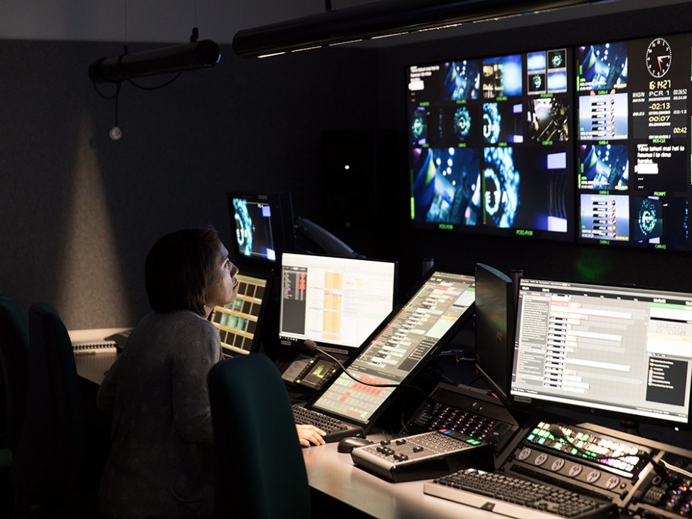 A technician monitors multiple screens in Maori Television's control suite during broadcast operations.