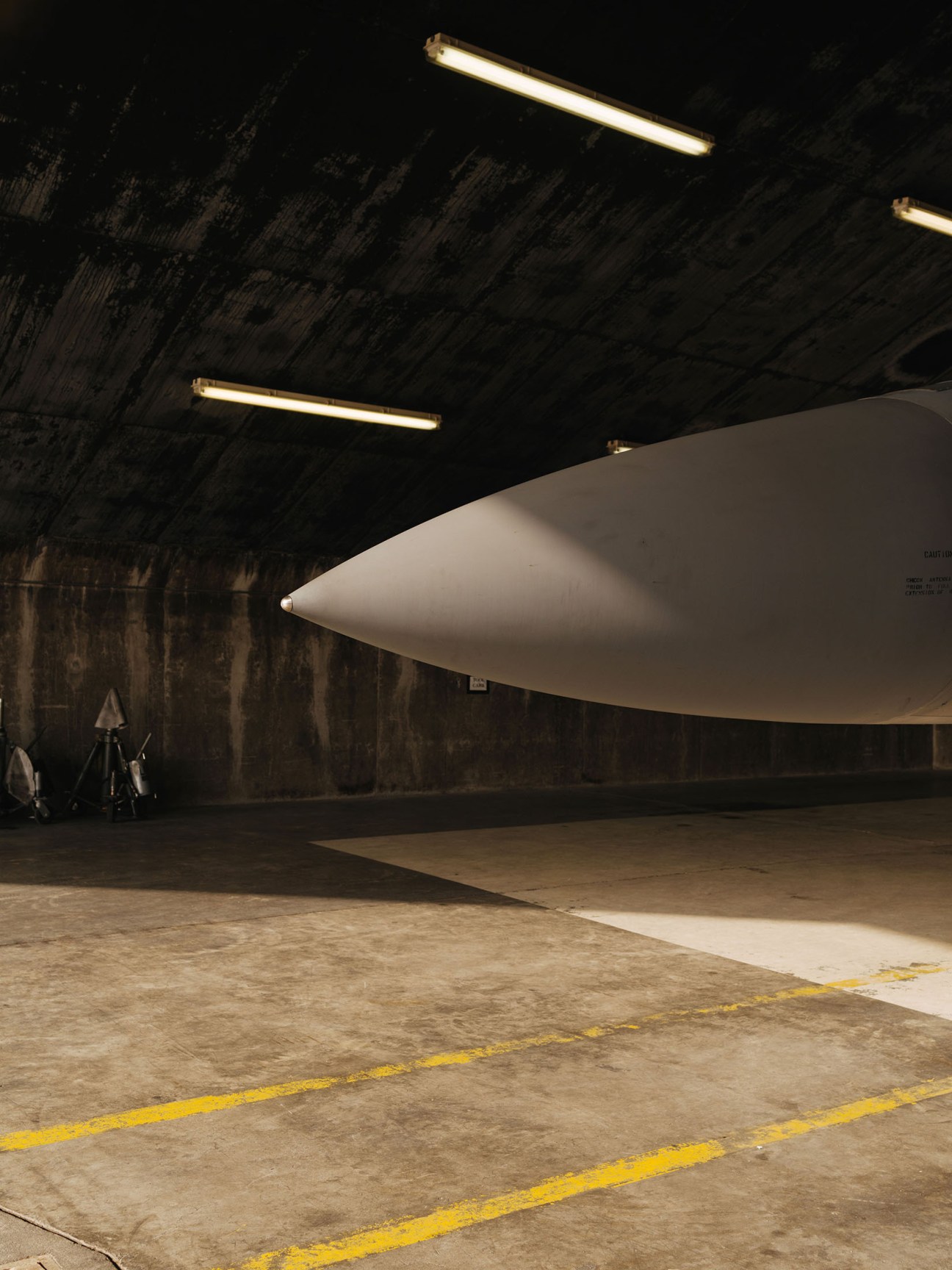 US military aircraft parked inside a concrete hangar at Keflavík air base in Iceland.