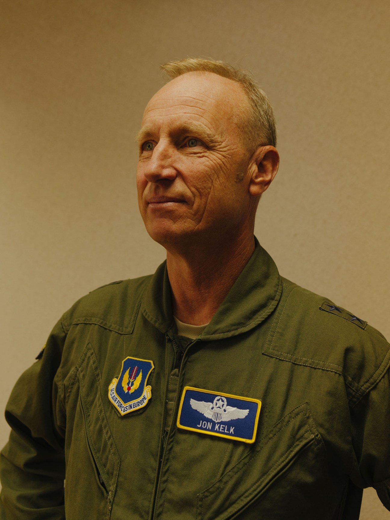 Major General Jon Kelk in olive green US Air Force flight suit with name patch and squadron insignia.
