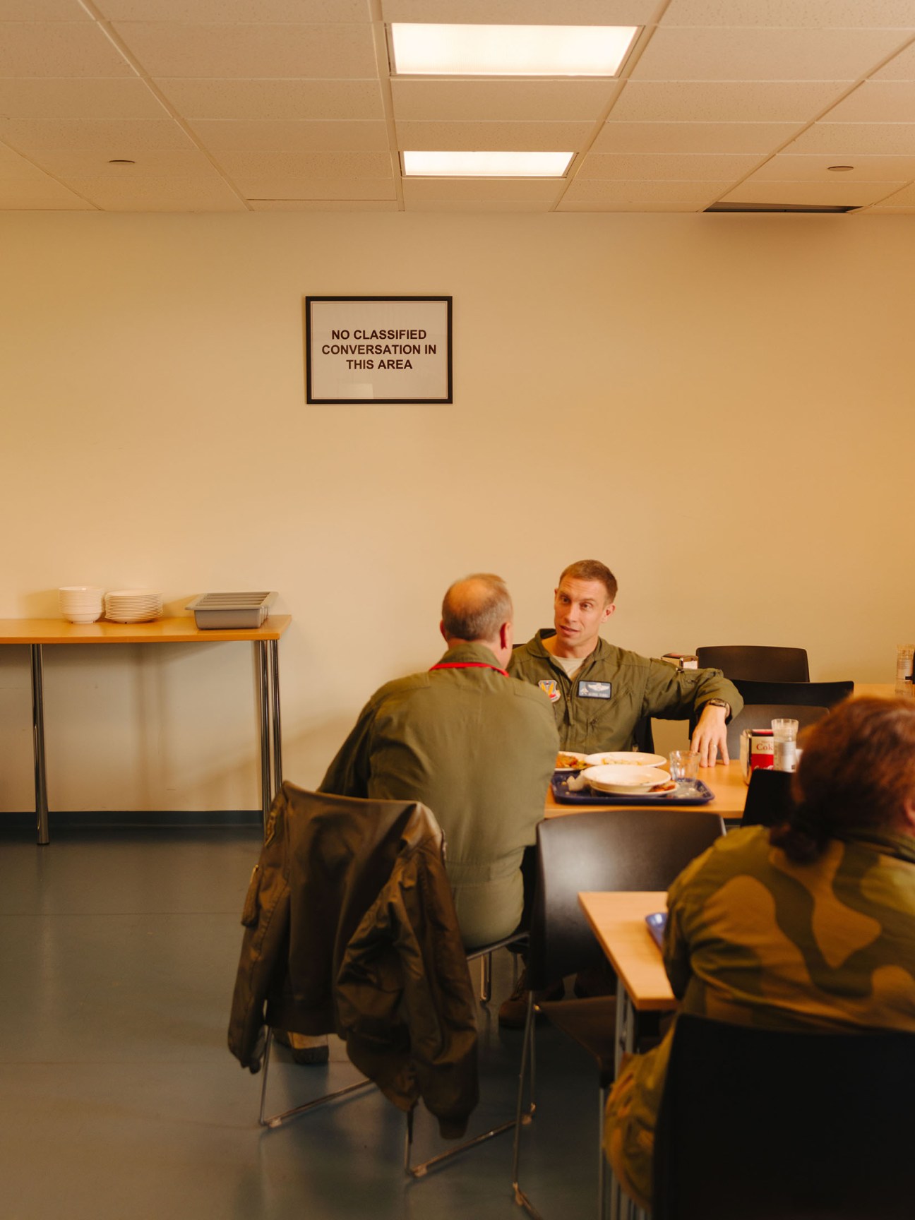 US airmen in military flight suits having a conversation in a break room at Keflavík air base.