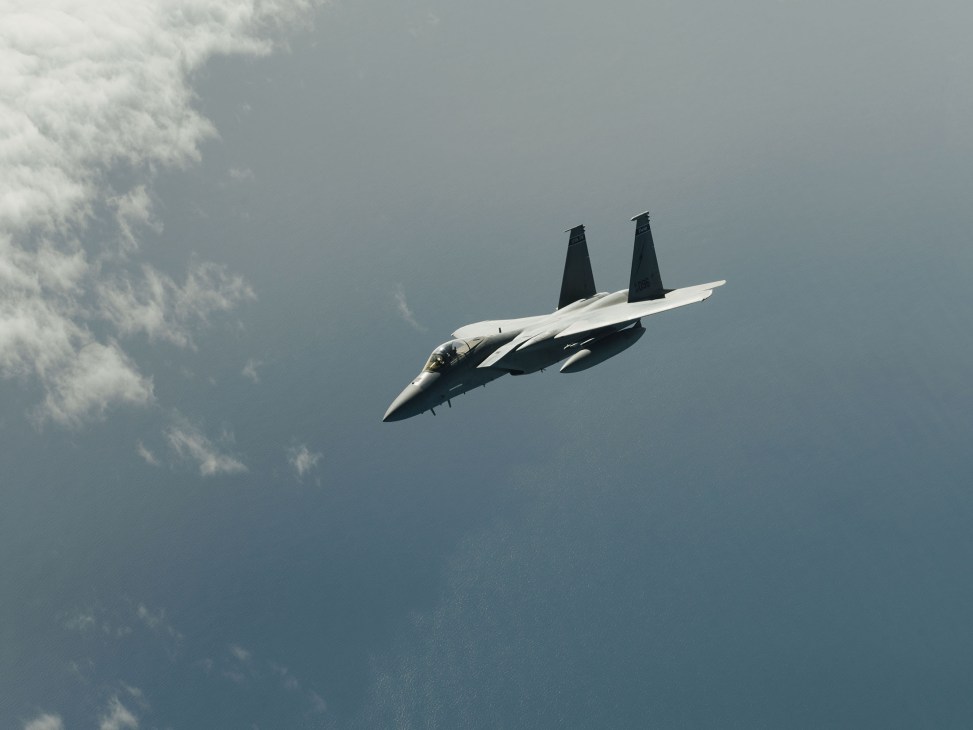 F-15C Eagle fighter jet in flight against cloudy sky