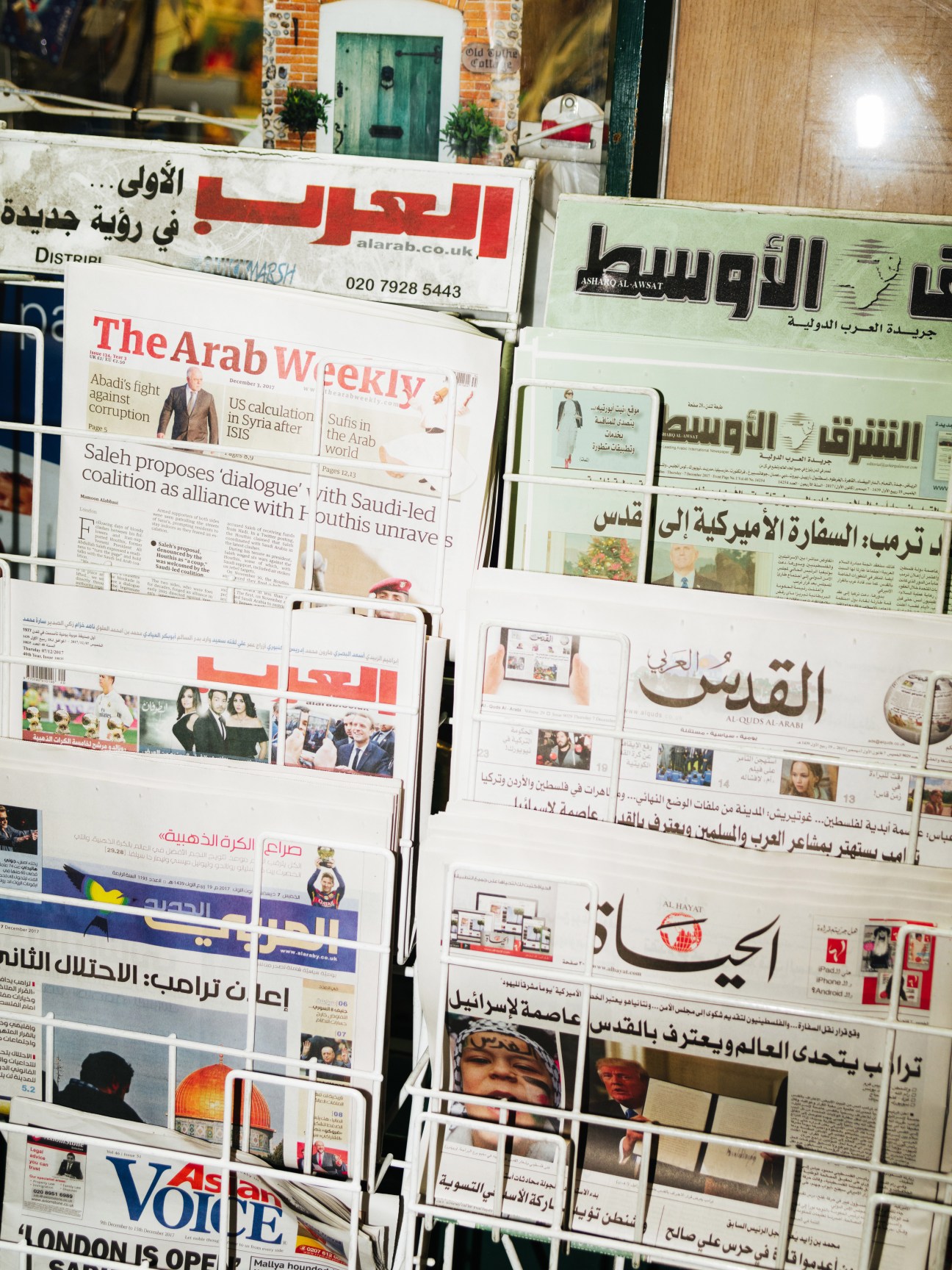 Display of Arab newspapers and publications at a London newsagent, including Asharq Alawsat, Al Quds Al Arabi, and The Arab Weekly.