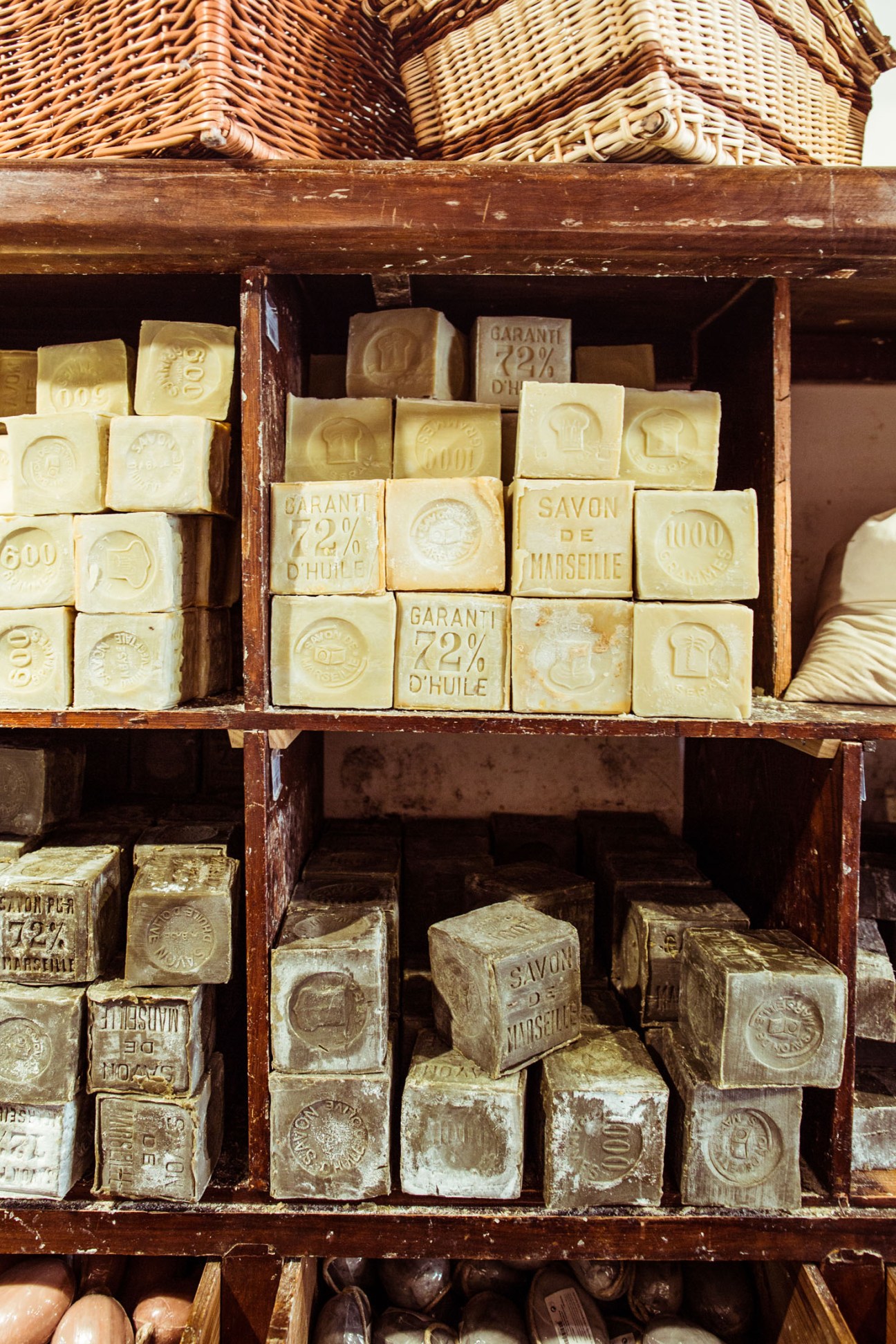 Bars of Savon de Marseille soap stacked in wooden cabinet drawers at Maison Empereur.