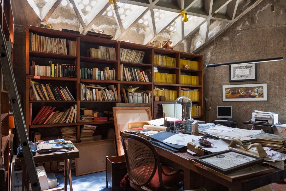 Ernesto Gallardo's study with wooden bookshelves, desk, and skylight ceiling featuring triangular hollows.