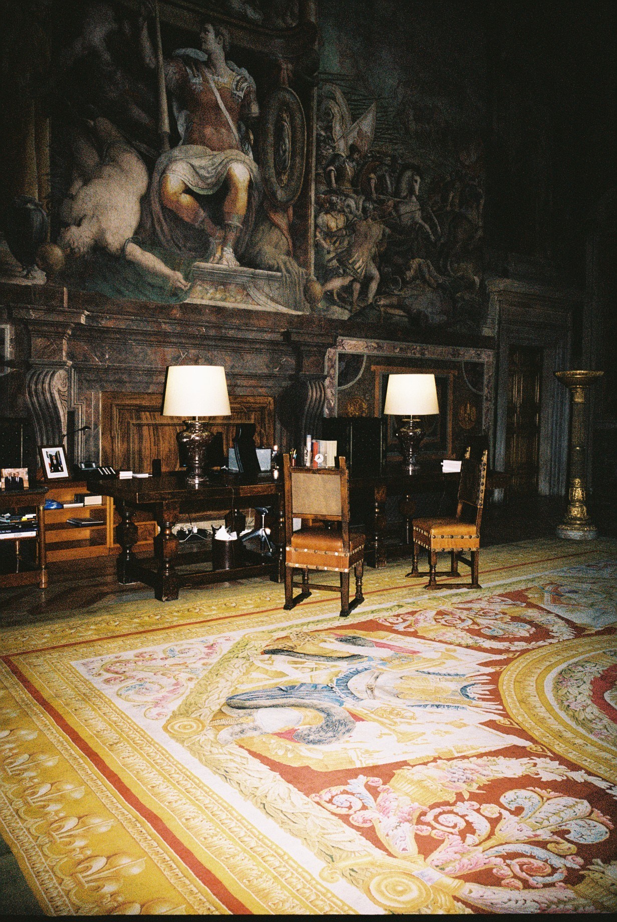 Ornate Renaissance interior with elaborate ceiling frescoes, antique furniture, Persian rugs and classical architectural details