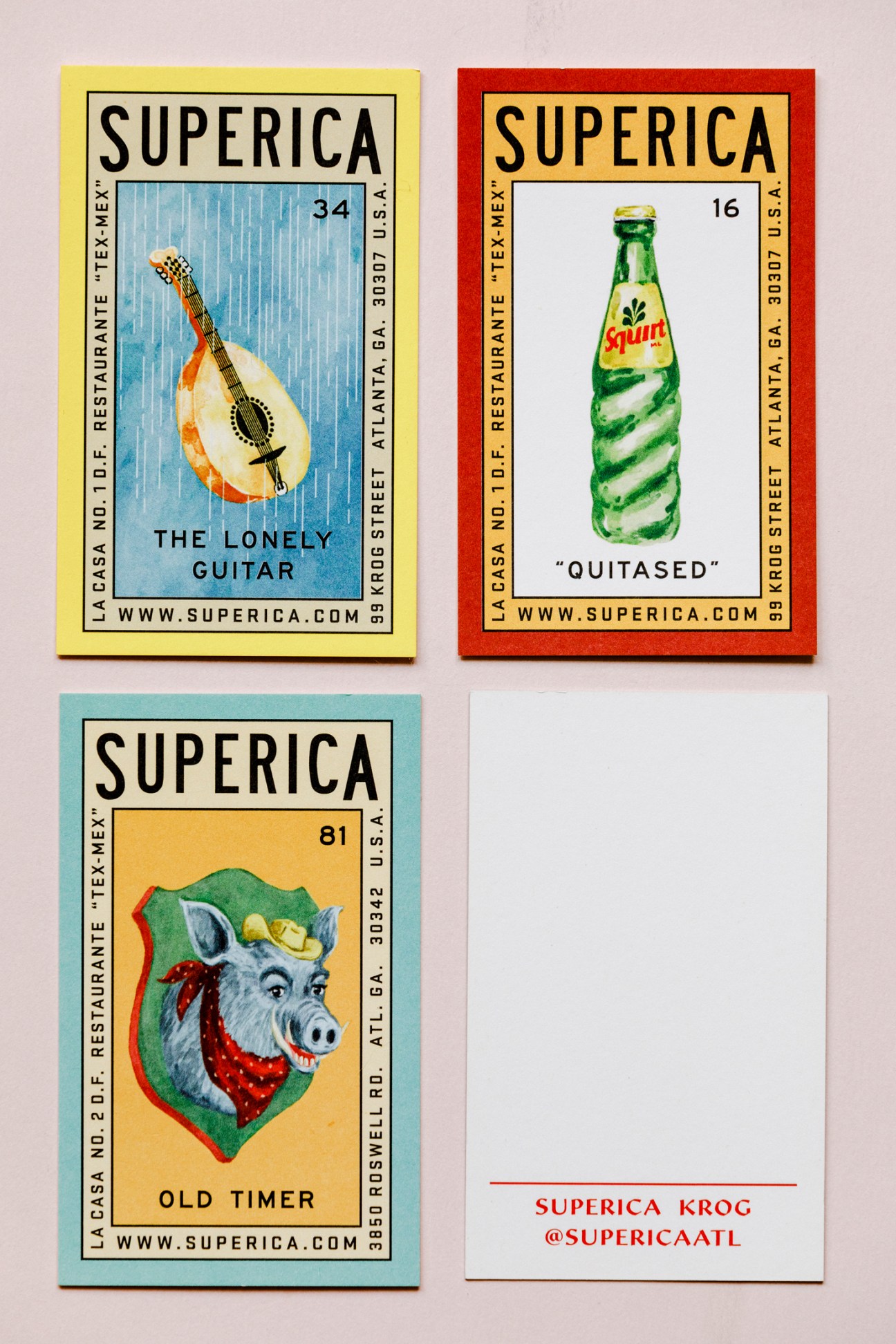 Three colorful Superica branded cards featuring illustrations of a guitar, bottle, and donkey head