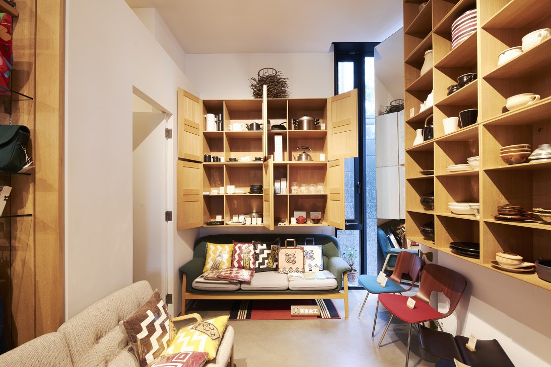 Interior of Fennica shop in Tokyo with wooden shelving, ceramics, and home goods displayed on shelves