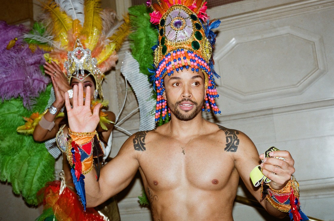 Two men in elaborate feathered headdresses and traditional carnival costumes at Vienna ball